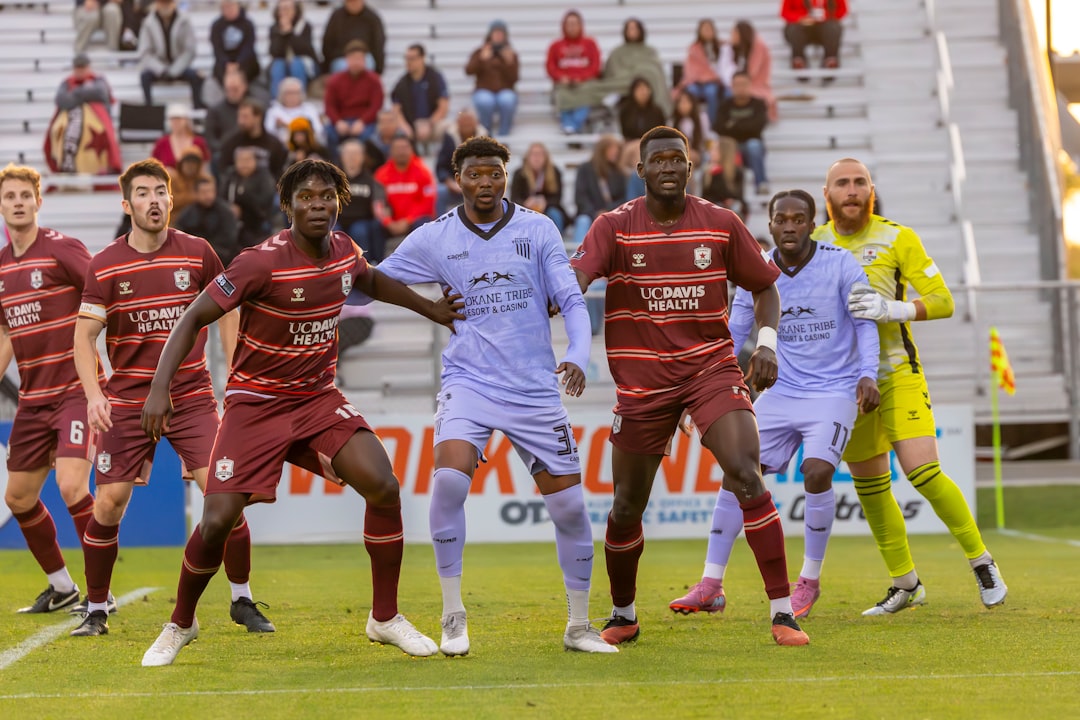 soccer-players-in-uniform-on-a-field-with-spectators-34hg8mkaki8