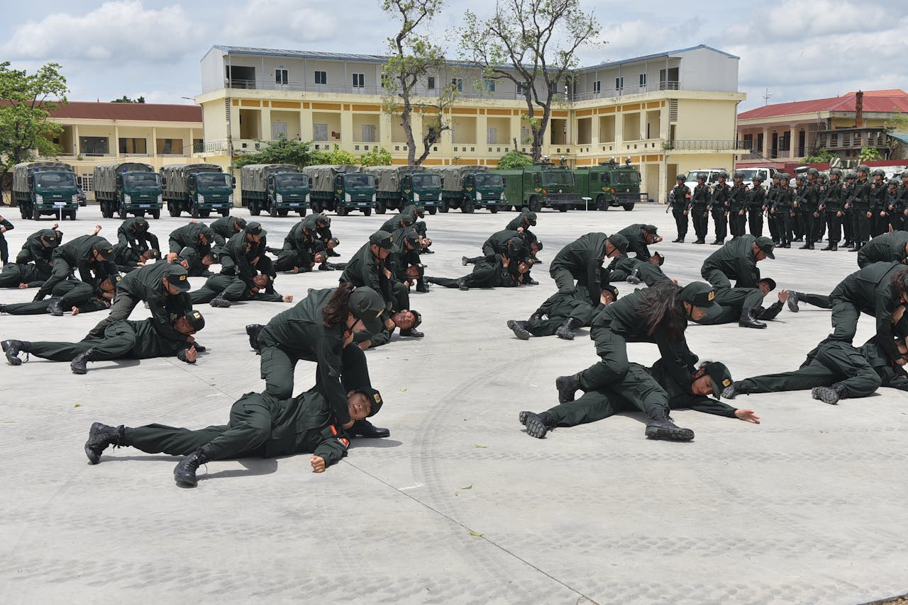 Soldiers practice defense tactics outdoors in a coordinated military training exercise.