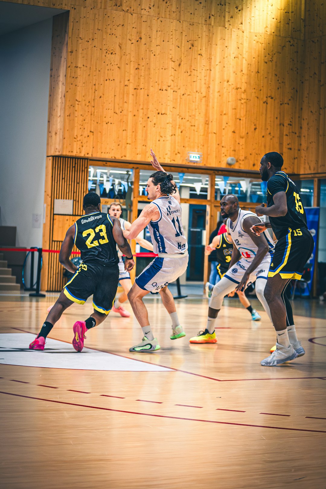 basketball-players-compete-on-a-wooden-court-indoors-xfdz9hvavi0